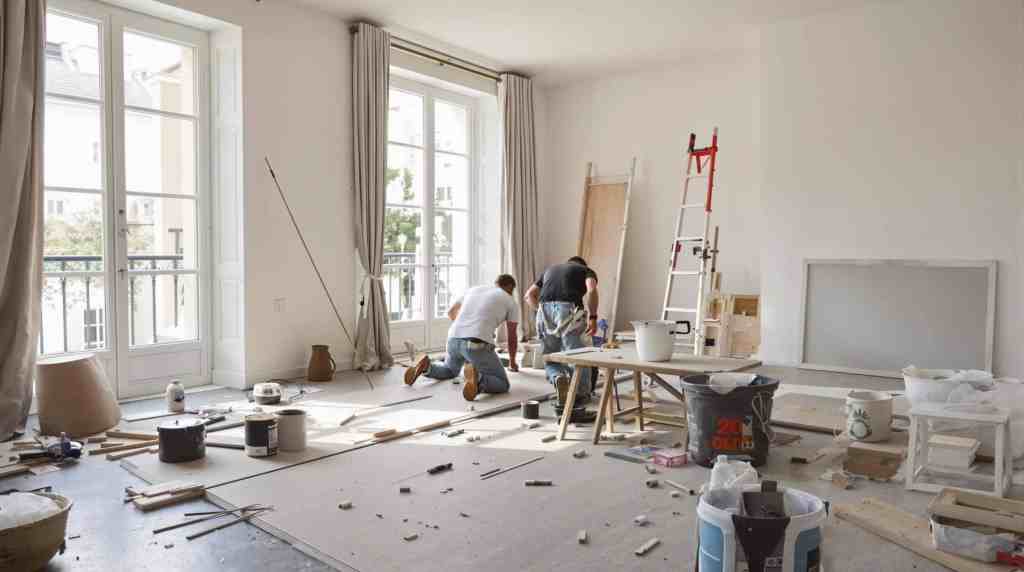 Two men renovating a bright, airy room