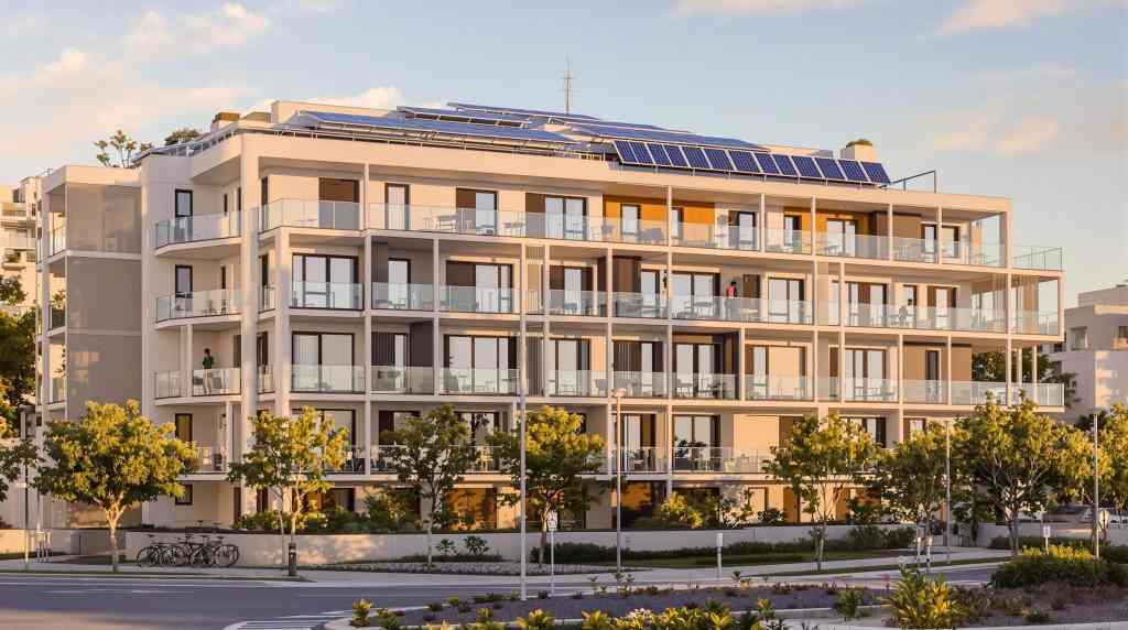 Modern apartment building with solar panels.